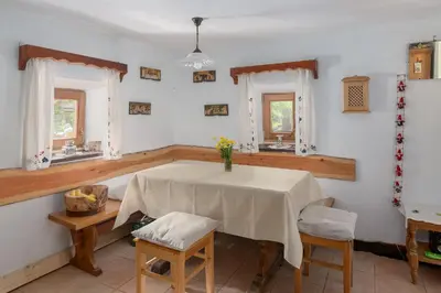 a dining room with a table and two chairs at Lizina hiška House Bohinj in Bohinjska Bistrica