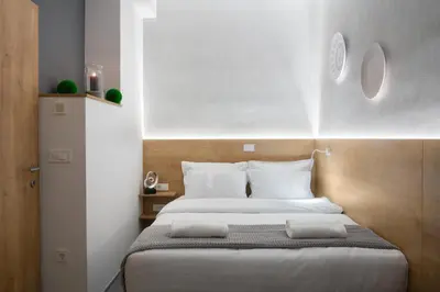 a bedroom with a bed with two pillows on it at Vila Emona - Central Apartments - Free Parking in Ljubljana