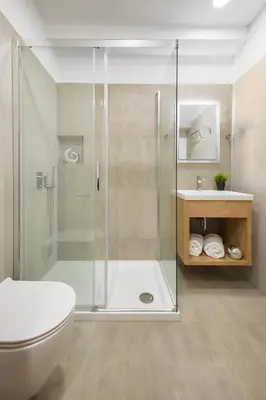 a bathroom with a shower and a toilet and a sink at Vila Emona - Central Apartments - Free Parking in Ljubljana