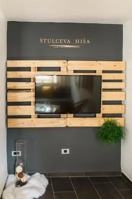 a microwave in a wooden box on a wall at Štulceva Hiša in Most na Soči