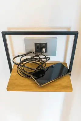 a cell phone on a table with a chain around it at Štulceva Hiša in Most na Soči