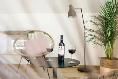 a table with a bottle of wine and two glasses at Štulceva Hiša in Most na Soči