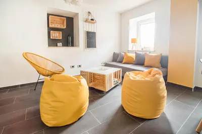 a living room with yellow chairs and a couch at Štulceva Hiša in Most na Soči