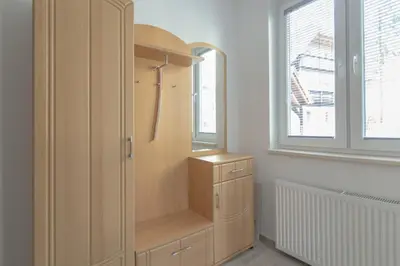 a wooden cabinet in a room with a window at Villa Melody in Bohinj