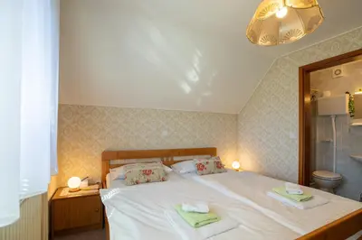 a bedroom with a bed with two towels on it at Sobe Ličef in Bohinj