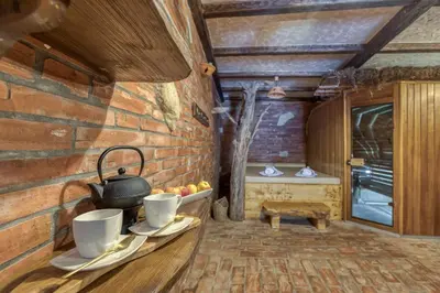a room with a table with cups and a pot on it at Bajsova domačija in Podčetrtek