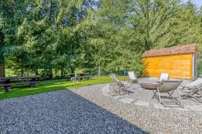 a group of chairs and a table and a cabin at Bajsova domačija in Podčetrtek