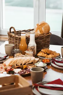 a table with bread and a basket of food at Bajsova domačija in Podčetrtek