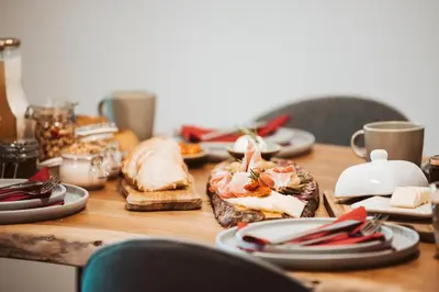 a wooden table with plates of food on it at Bajsova domačija in Podčetrtek