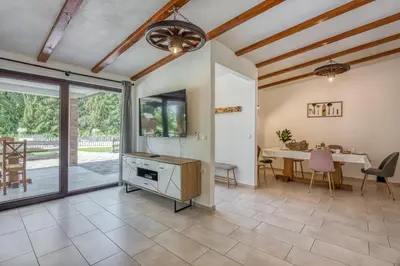 a living room with a ceiling fan and a table at Bajsova domačija in Podčetrtek