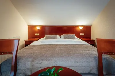 a bedroom with a large bed with two night stands at Kala B&B in Kranjska Gora