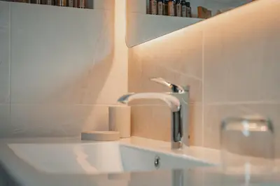 a bathroom sink with a faucet and a towel at Kala B&B in Kranjska Gora