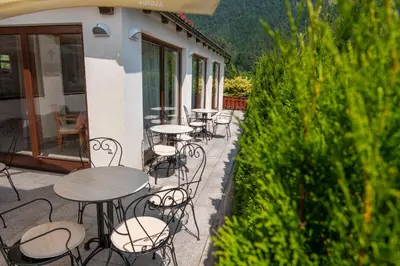 a row of tables and chairs on a patio at Kala B&B in Kranjska Gora