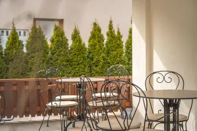 a group of chairs and tables on a balcony at Kala B&B in Kranjska Gora