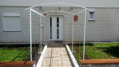 a building with an archway in front of a door at Divača, Vila Srebrna in Divača