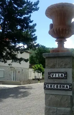 a street sign with a vase on top of a pillar at Divača, Vila Srebrna in Divača
