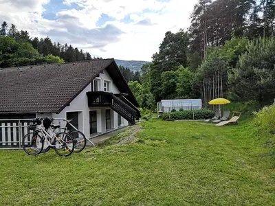 a bike parked in front of a house at Apartma Juteršek in Libeliče