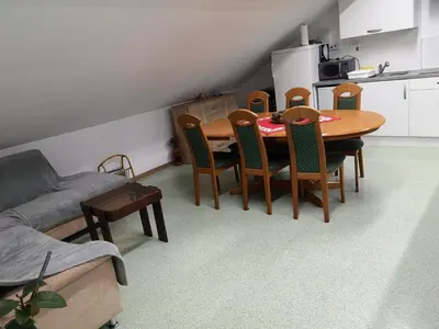 a kitchen with a dining room table and chairs at Apartma Juteršek in Libeliče