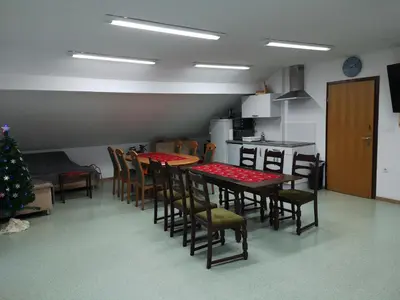 a kitchen with a table and chairs and a christmas tree at Apartma Juteršek in Libeliče