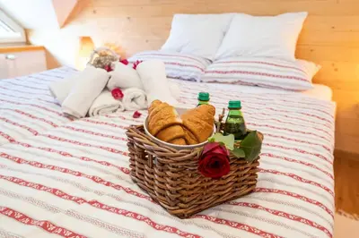 a basket of towels and bottles on a bed at Bohinj - Apartment Ana in Bohinj