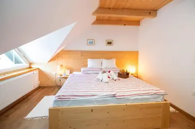 a bedroom with a large bed with two stuffed animals on it at Bohinj - Apartment Ana in Bohinj