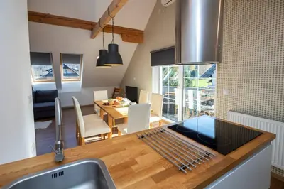 a kitchen and dining room with a sink and a table at Bohinj - Apartment Ana in Bohinj