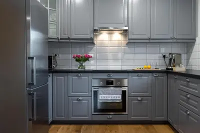 a kitchen with gray cabinets and an oven at Hiša MIHA Stunning Spacious House & Apartment Podkoren Kranjska Gora in Kranjska Gora
