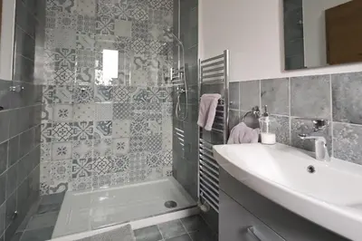 a bathroom with a sink and a shower and a tub at Hiša MIHA Stunning Spacious House & Apartment Podkoren Kranjska Gora in Kranjska Gora