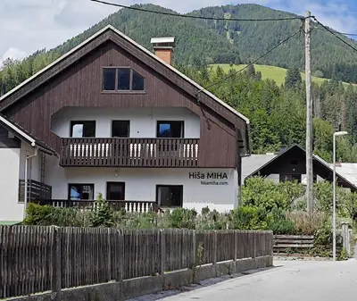 a wooden house with a balcony on top of it at Hiša MIHA Stunning Spacious House & Apartment Podkoren Kranjska Gora in Kranjska Gora