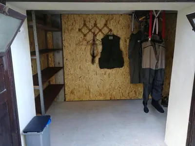 a small room with clothes hanging on a wall at ZRM center in Idrija