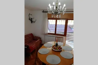 a dining room table with a bowl of fruit on it at ZRM center in Idrija