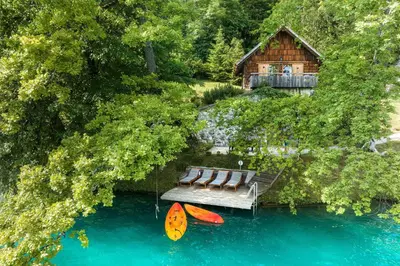 an aerial view of a house and two kayaks in the water at Private beach house on Lake Bled in Bled