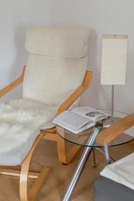 a white chair with a table and a laptop at OPN Apartments Bled in Bled