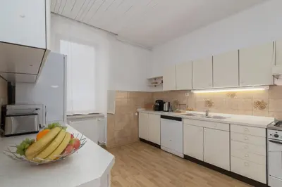 a kitchen with a bowl of fruit on a counter at OPN Apartments Bled in Bled