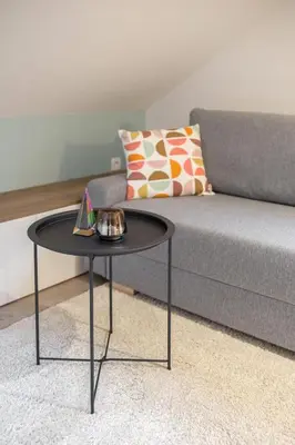 a black coffee table in front of a couch at OPN Apartments Bled in Bled