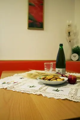 a table with a plate of food and a bottle at Apartma Pegaz in Rogaška Slatina
