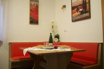 a table with a bowl of fruit and a bottle of wine at Apartma Pegaz in Rogaška Slatina