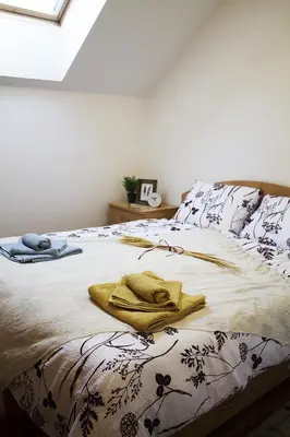 a bed with a blanket and a towel on it at Apartma Pegaz in Rogaška Slatina