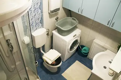 a small bathroom with a toilet and a sink at Apartma Pegaz in Rogaška Slatina