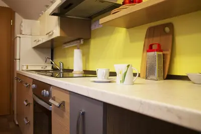 a kitchen counter with two cups and a sink at Apartma Pegaz in Rogaška Slatina