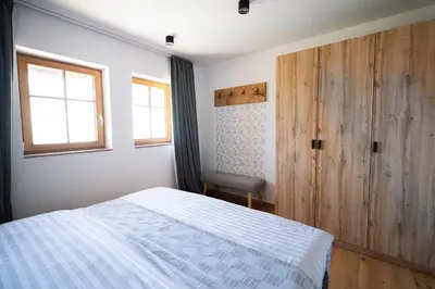 a bedroom with a bed and a wooden door at SKED'N in Bled