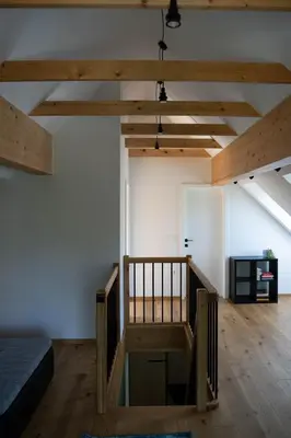 a room with a bed and a wooden floor at SKED'N in Bled
