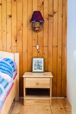 a table with a picture on it next to a bed at House Moose't Getaway, Kranjska Gora in Kranjska Gora