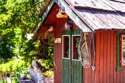a red and green house with two windows at House Moose't Getaway, Kranjska Gora in Kranjska Gora