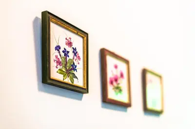 four pictures of flowers are hanging on a wall at House Moose't Getaway, Kranjska Gora in Kranjska Gora