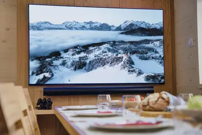 a picture of a mountain on the wall of a restaurant at Luxury Alpine Chalet & Sauna Pinja - Velika Planina - I FEEL ALPS in Stahovica