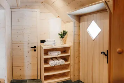 a tiny house with a closet with towels at Chalet Lepenatka with Sauna - I feel Alps in Stahovica