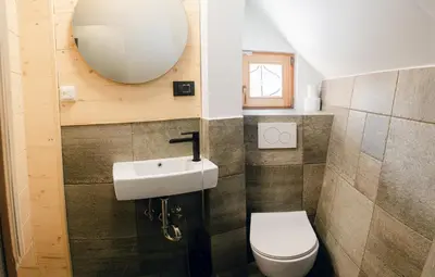 a bathroom with a white toilet and a sink at Chalet Lepenatka with Sauna - I feel Alps in Stahovica