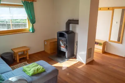 a living room with a wood stove in it at house on the top of the hill in Mozirje