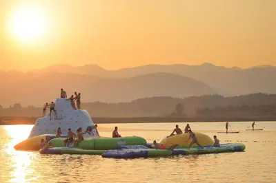 a group of people on a raft in the water at house on the top of the hill in Mozirje